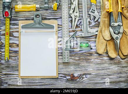 Clipboard construction tools on wooden board top view. Stock Photo