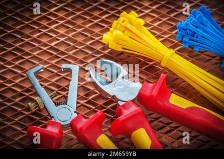 Insulation wire strippers cutter tying cables on dielectric mat. Stock Photo