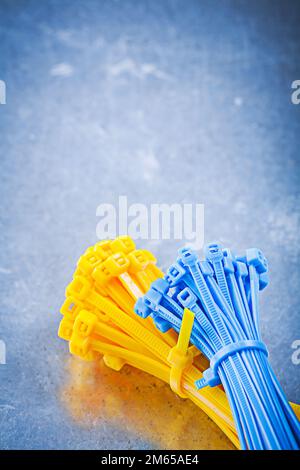 Set of self-locking cable ties on metallic background construction concept. Stock Photo