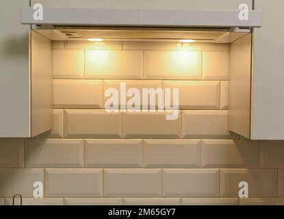 the wall in the kitchen is lined with white rectangular tiles Stock Photo