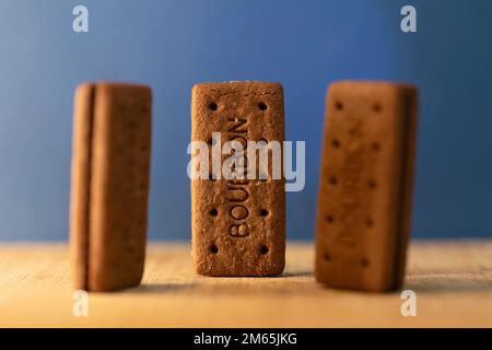 Bourbon Creams - A traditional chocolate biscuit displayed on a blue background.Sweet food often eaten with a cup of tea. Stock Photo