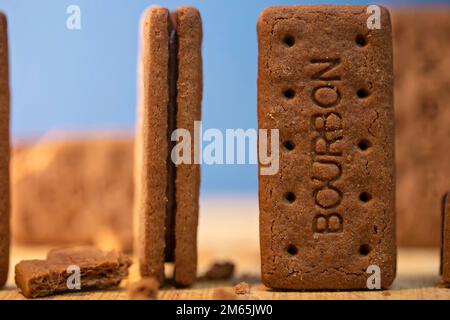 Bourbon Creams - A traditional chocolate biscuit displayed on a blue background.Sweet food often eaten with a cup of tea. Stock Photo