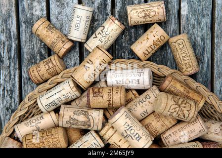 Corks spilling out of basket Stock Photo