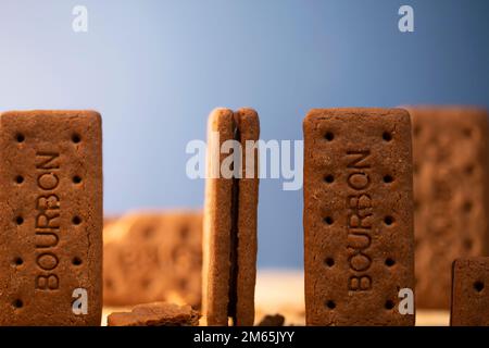 Bourbon Creams - A traditional chocolate biscuit displayed on a blue background.Sweet food often eaten with a cup of tea. Stock Photo