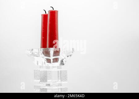 two red candles in clear glass sculptured candle holders Stock Photo