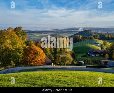 Peaceful autumn sunny morning rural view from Gmundnerberg with misty countryside in far, Altmunster am Traunsee, Upper Austria. Stock Photo