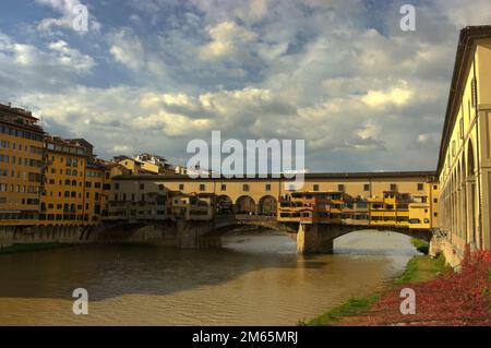 Arno river as it passes through the city of Florence in Tuscany with the old bridge in the background. Stock Photo