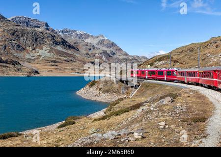 bernina express mountain railway train approaching ospizio bernina Stock Photo