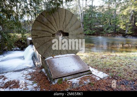 Old millstone from a water mill that stood on a stream in New Brunswick, Canada Stock Photo