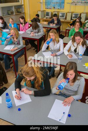Netherlands - Students drinking water during a long test at school in  Arnhem Stock Photo