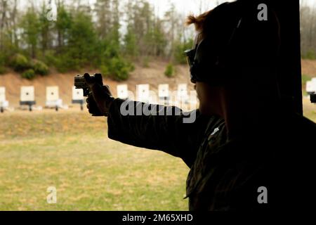 U.S. Marine Corps Sgt. Shaun Muller, headquarters platoon sergeant, 2nd Battalion, 8th Marines, from Long Island, New York, aims his pistol during pistol training for the Marine Corps Marksmanship Championship at Marine Corps Base Quantico, Virginia, April 5, 2022.  The Marine Corps Championship held, April 6-11, allows competitors to participate in a variety of matches while receiving advanced marksmanship training. Shooters from around the Marine Corps were selected for the championship during five regional matches, coordinated by the Marine Corps Shooting Team, October 2021 through March 20 Stock Photo