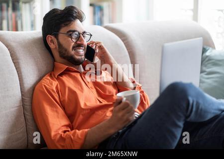 Handsome arabic man resting at home, using laptop Stock Photo