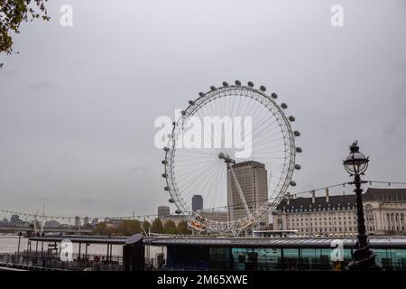 The London Eye on a rainy day in the River Thames in London, England Stock Photo