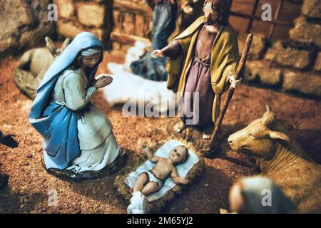 Close-up details of a traditional Christmas nativity crib scene with painted figurines Stock Photo