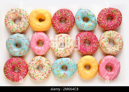 Colorful delicious donuts isolated on white background Stock Photo