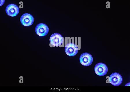 Blue spot lights in a row, exhibition hall illumination equipment Stock Photo
