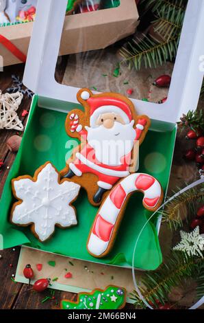 Box of Gingerbread Cookies on Dark Wooden Background, Set of Christmas Treats Stock Photo