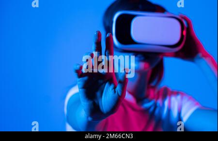 Brunette woman architect or engineer working with virtual reality, young woman testing VR glasses or goggles in studio. Stock Photo
