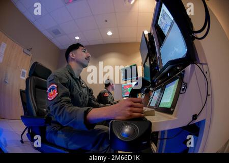 U.S. Air Force Airmen operate an MQ-9 Reaper simulator during Reaper Smoke 2022 at Creech Air Force Base, Nevada, April 6, 2022. Nearly 45 MQ-9 Reaper crews from across the United States competed in the base’s flight simulators to hone in on their tactical acumen, partake in a competition to build camaraderie and celebrate the victories in the RPA community. MQ-9 Reaper,Reaper Smoke,competition,creech afb,reaper,simulators, Stock Photo