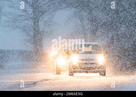 Cars driving in snow - Scotland, UK Stock Photo