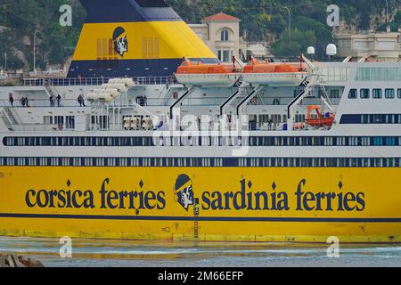 View of a yellow ferryboat Corsica Sardinia Ferries in the Port of Nice harbor. Nice, France - December 2022 Stock Photo