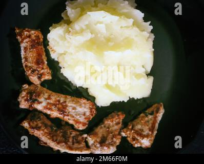 meat and mashed potatoes on dark backroynd Stock Photo