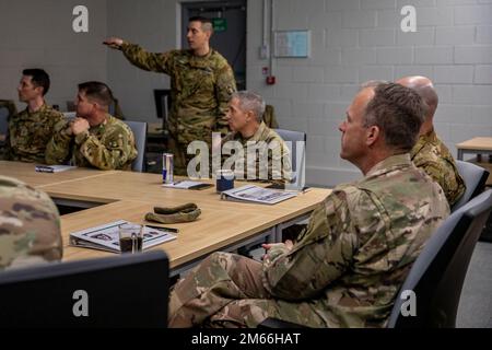 U.S. Army Maj. James Raymond, operations officer, 1-3rd Attack Battalion, briefs Lt. Gen. John S. Kolasheski, commanding general of V Corps, at Lielvarde Air Base, Latvia, on April 7, 2022. 12 CAB is among other units assigned to V Corps, America's Forward Deployed Corps in Europe that works alongside NATO Allies and regional security partners to provide combat-ready forces, execute joint and multinational training exercises, and retains command and control for all rotational and assigned units in the European Theater. Stock Photo