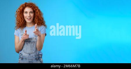 Gotcha. Cool sassy good-looking redhead curly woman pointing camera finger pistols cheeky introduction smiling excited having fun congratulating Stock Photo