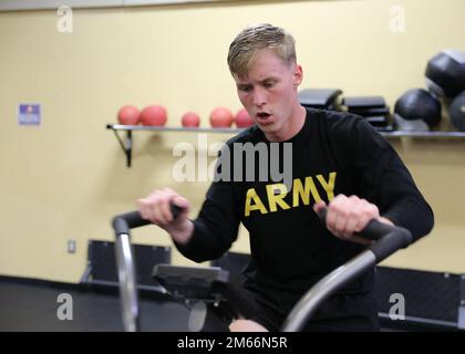 Spc. Kenneth Rayne, an engineer Soldier assigned to the 'Gila Battalion,' 9th Brigade Engineer Battalion, 2nd Armored Brigade Combat Team, 3rd Infantry Division, conducts an anaerobic stationary bike exercise during a rigorous culminating workout in preparation for the 15th Annual Lt. Gen. Robert B. Flowers Best Sapper Competition at Fort Leonard Wood, Missouri, on Fort Stewart, Georgia, April 8, 2022. Nearly every year engineer Soldiers across the Marne Division train for the Best Sapper Competition to improve their occupational skills and become an expert in their craft. Stock Photo