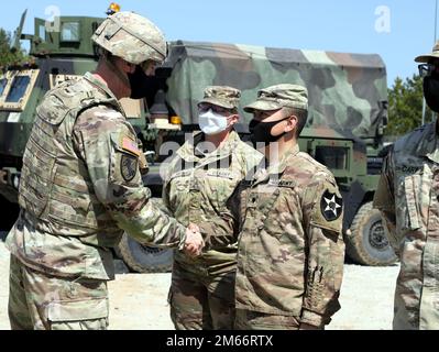 Maj. Gen. David Lesperance, the commanding general of the 2nd Infantry Division/ROK-US Combined Division, presents a coin to Spc. Josue Valesquez, a medic with the 1st Battalion, 38th Field Artillery Regiment, 210th Field Artillery Brigade during a visit to the unit on Apr. 8, 2022. Stock Photo