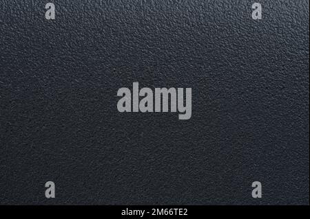 Rough  black grainy plastic background close up view Stock Photo