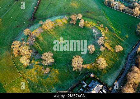 Mayburgh Henge prehistoric monument at Eamont Bridge, Cumbria, showing massive circular embankment and remaining central megalith. Aerial winter Stock Photo