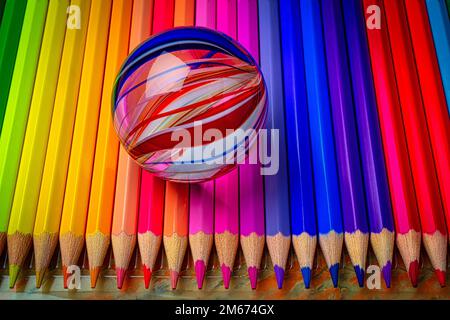 Marble On Colored Pencils Stock Photo