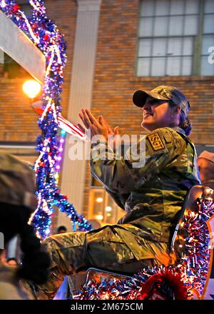 Senior Master Sgt. Tania McGuire, 433rd Civil Engineer Squadron first sergeant, claps along to music during the San Antonio Fiesta Flambeau Parade, April 9, 2022. Stock Photo