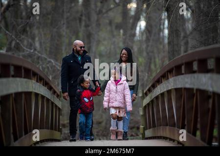 Cleveland Brown V walks with his family, Maj. Nina Brown, 436th Operational Medical Readiness Squadron clinical nurse, right, Cleveland Brown VI, 4, bottom left and Kennedy-Jade Brown, 6, bottom right at Silver Lake Park in Dover, Delaware, April 9, 2022. Brown served in the United States Air Force for six years and has been a military spouse for nine. Stock Photo