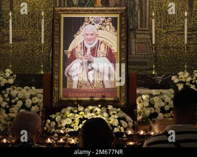 Manila, Philippines. 02nd Jan, 2023. The portrait of the deceased Pope Emeritus Benedict XVI is installed at Christ the King Chapel in Manila Cathedral. Catholic devotees pay their last respect to Pope Emeritus Benedict XVI by offering prayers, lighting of candles, and writing the book of condolences for the late pontiff at the Christ the King Chapel of the Manila Cathedral on Monday, January 2. The late pope whose birth name was Joseph Aloisius Ratzinger died at the age of 95 last December 31, 2022 at the Mater Ecclesiae Monastery in Vatican City. Credit: SOPA Images Limited/Alamy Live News Stock Photo