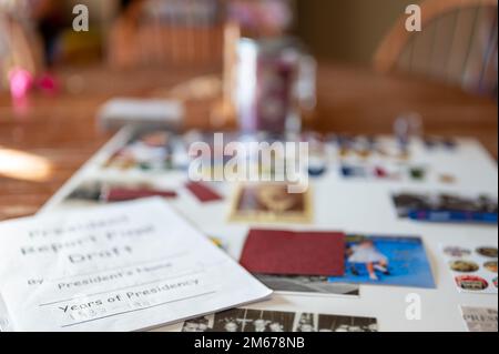 Defocused school book report poster board with pictures and text. Written report on top.  Stock Photo