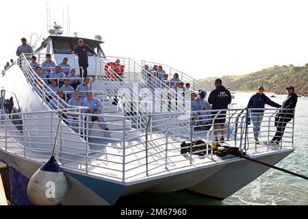 Sunburst Youth Challenge Academy Class 29 cadets from Panthers Platoon are on a ferry boat, April 10, 2022, to depart Camp Emerald Bay on a remote part of Catalina Island for their return to San Pedro, California, and their campus on Joint Forces Training Base, Los Alamitos, California. As part of Sunburst’s active community service program, the academy traveled to Camp Emerald Bay to help the camp’s small off-season maintenance team prepare the grounds for its peak summer Scouting season. Stock Photo