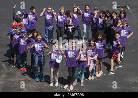 Students with Stuart Mesa Elementary School form a heart while posing for a photo on Marine Corps Base Camp Pendleton, California, April 11, 2022. The Month of the Military Child is celebrated annually in April to honor the sacrifices made by approximately 1.7 million children, emphasizing the experiences of the dependent children of service members serving at home and overseas. Stock Photo