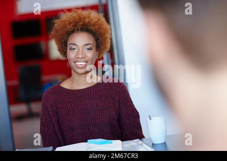 Theyve got some winning ideas between each other. two colleagues having a discussion in the office. Stock Photo