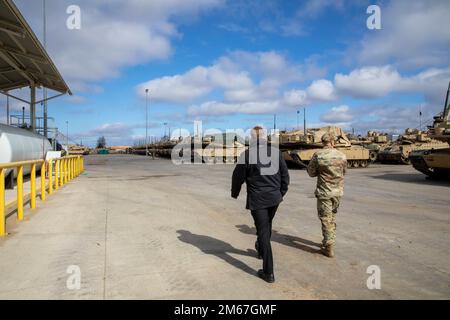 U.S. Army Lt. Col. Paul Godson, commander of 3rd Battalion, 66th Armored Regiment, 1st Infantry Division, gives Lithuanian Archbishop Gintaras Grušas a tour of Camp Herkus, Lithuania, April 12, 2022. Stock Photo