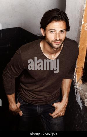 Rustic and rugged. Portrait of a handsome young man with his hands in his pockets. Stock Photo