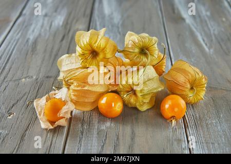 Peruvian physalis, Cape gooseberry Fresh peachberry very tasty and healthy berries, on a wooden table Stock Photo