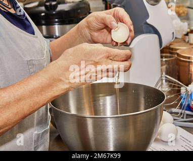 Chef separates the yolk from the protein to make the pie Stock Photo
