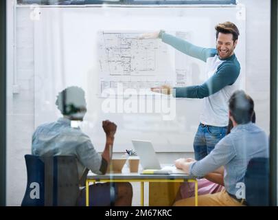 Building an office and his career. a group of architects discussing plans. Stock Photo