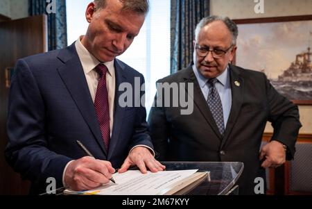 WASHINGTON (April 13, 2022) — The Honorable Erik K. Raven, left, is sworn in as the 34th Under Secretary of the Navy by Secretary of the Navy Carlos Del Toro April 13, 2022. Raven was confirmed as the 34th Under Secretary of the Navy April 7, 2022. Stock Photo