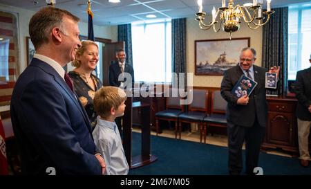 WASHINGTON (April 13, 2022) — The Honorable Erik K. Raven, left, with family, is sworn in as the 34th Under Secretary of the Navy by Secretary of the Navy Carlos Del Toro April 13, 2022. Raven was confirmed as the 34th Under Secretary of the Navy April 7, 2022. Stock Photo