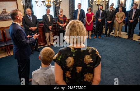 WASHINGTON (April 13, 2022) — The Honorable Erik K. Raven, left, with family, is sworn in as the 34th Under Secretary of the Navy by Secretary of the Navy Carlos Del Toro April 13, 2022. Raven was confirmed as the 34th Under Secretary of the Navy April 7, 2022. Stock Photo