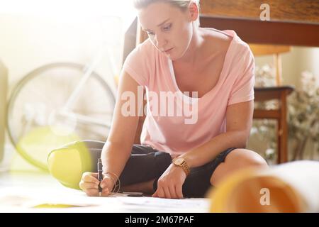 Art - the only way to run away without leaving home. a female graphic artist working on illustrations at home. Stock Photo