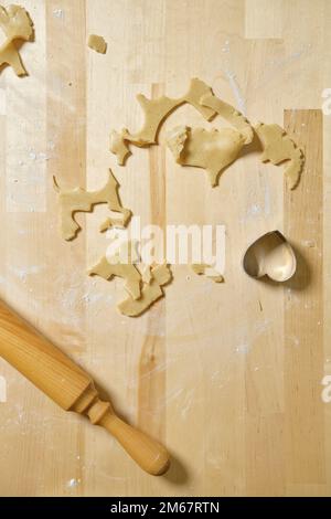 Top view of kitchen table with rests and cuts of cookie dough Stock Photo